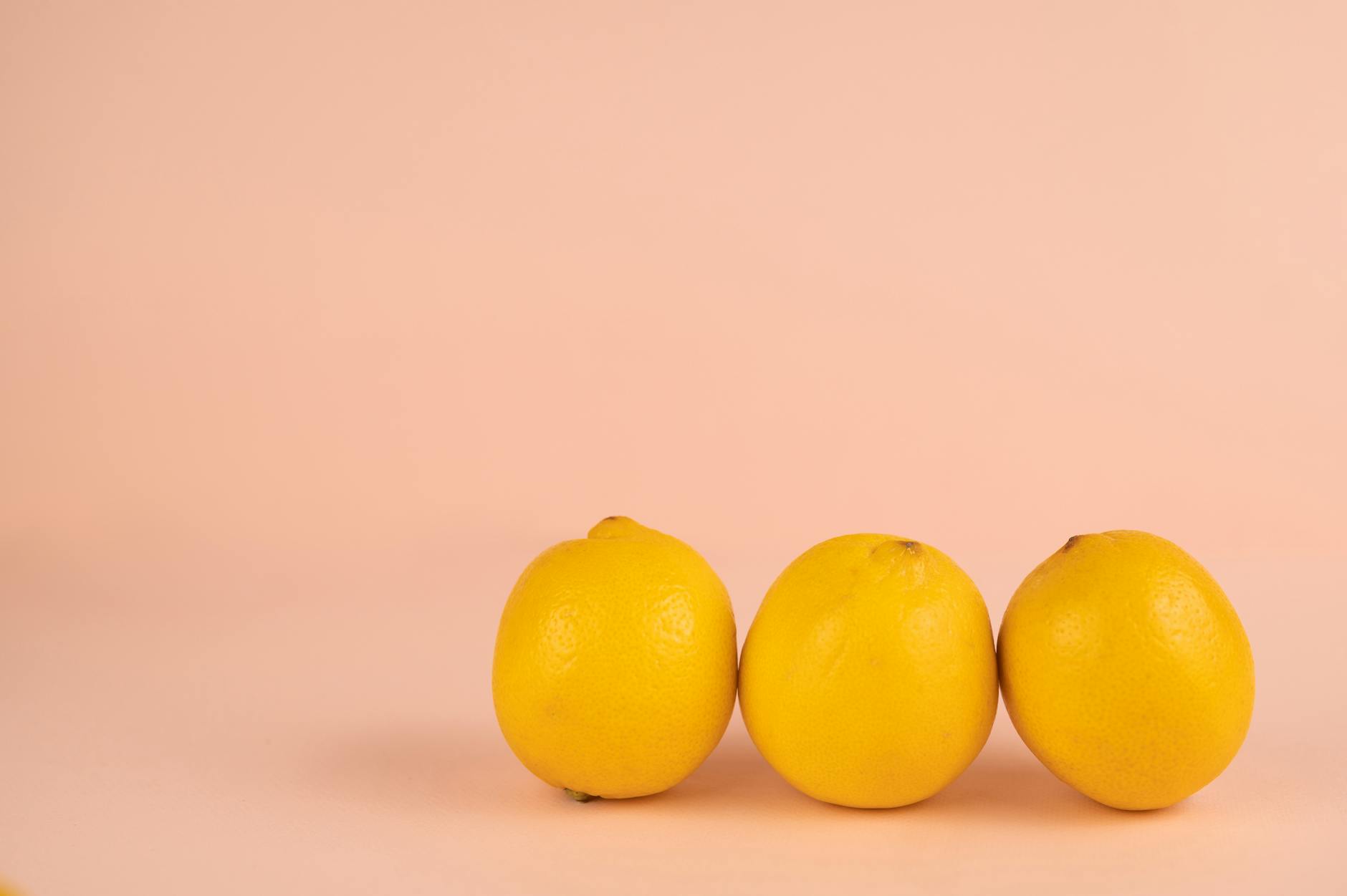 Two people smiling with fresh lemons, expressing joy and comfort together